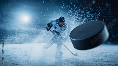 Fotografía Ice Hockey Rink Arena: Professional Player Shooting the Puck with Hockey Stick