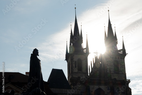 the Silhouette of Jan Hus Memorial look at Church of the Virgin Mary in Old Town Square in Prague at sunrise. photo