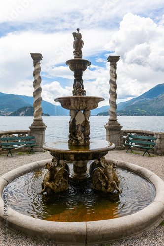 Beautiful fountain right in front of the stunning lake Como in Lombardy, Italy. It is a little overcast, but very nice summer day © brianholm