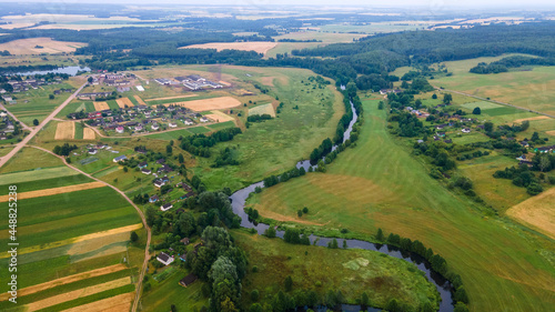 Fototapeta Naklejka Na Ścianę i Meble -  Aerial landscape of winding river in green field, top view of beautiful nature background from drone, seasonal summer landscape with copy space.