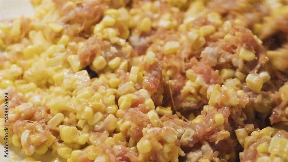 Minced pork get mixing with corn on a bowl. Macro shot. Snack and protein menu. Asian food menu. Thai food. Minced pork get mixing with corn on a bowl. Macro shot. Snack and protein menu. Asian food menu. Thai food.