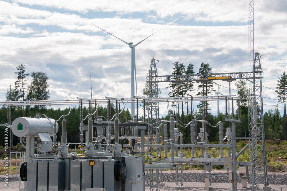 Power plant with wind turbines in background Power plant with wind turbines in background
