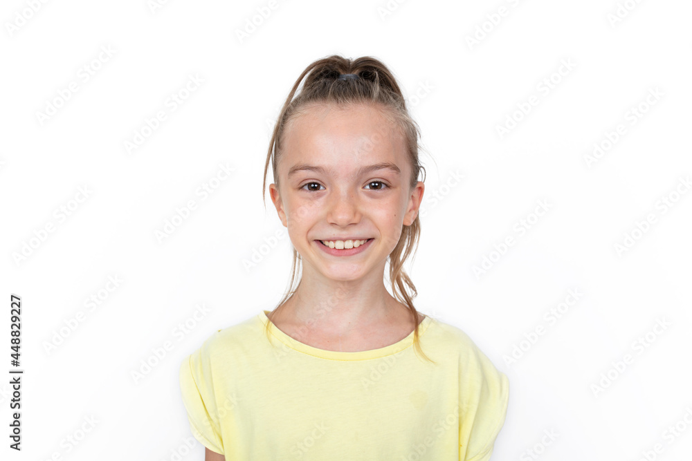 Happy girl standing, smiling isolated on white studio background Happy girl standing, smiling isolated on white studio background