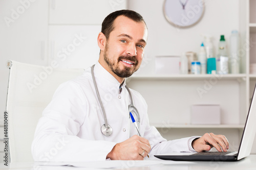 Positive male doctor ready to receive clients in his office