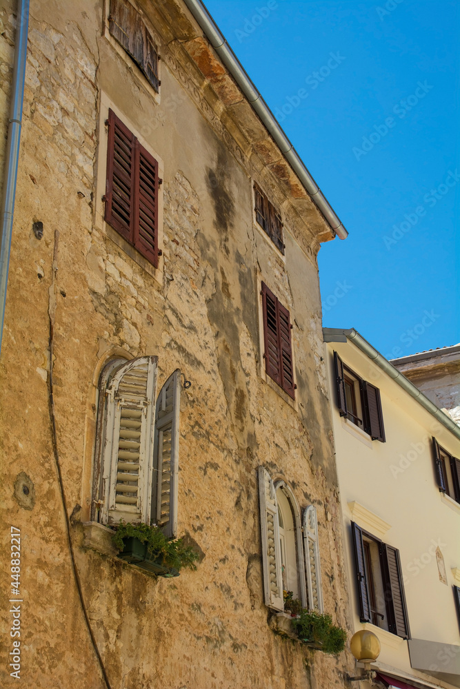 An old stone residential building in the historic medieval coastal town of Porec in Istria, Croatia
