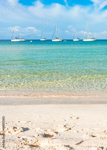 Boats in turquoise water beach in Minorca