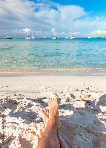 Relaxing in front of boats in turquoise water