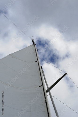 White Sail Under Cloudy Sky