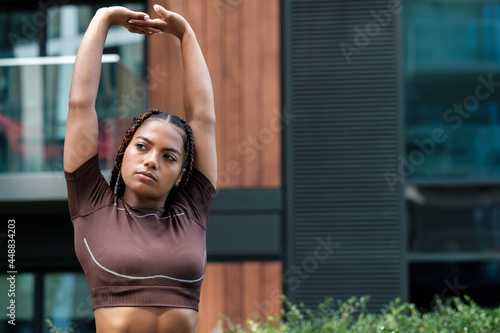 Fitness young woman stretching outdoors.