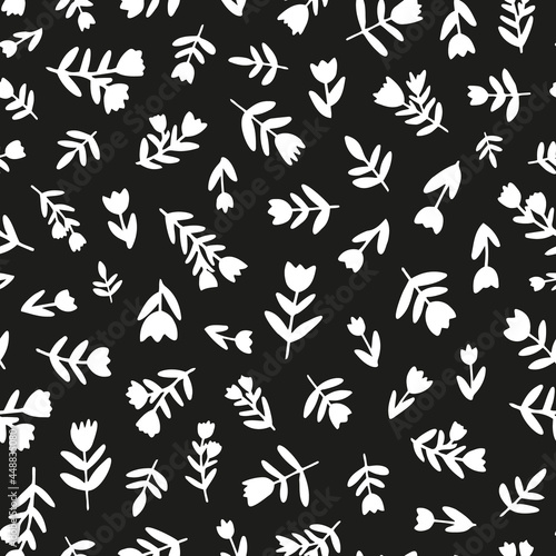 White silhouette flowers and leaves seamless repeat pattern. Random placed  vector botanical all over print on black background. Perfect as background  wallpaper  textile  fashion print and more.