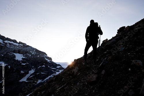 A man standing on top of a snow covered mountain