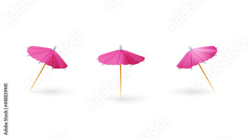 Pink paper 3D cocktail umbrella isolated on white background photo
