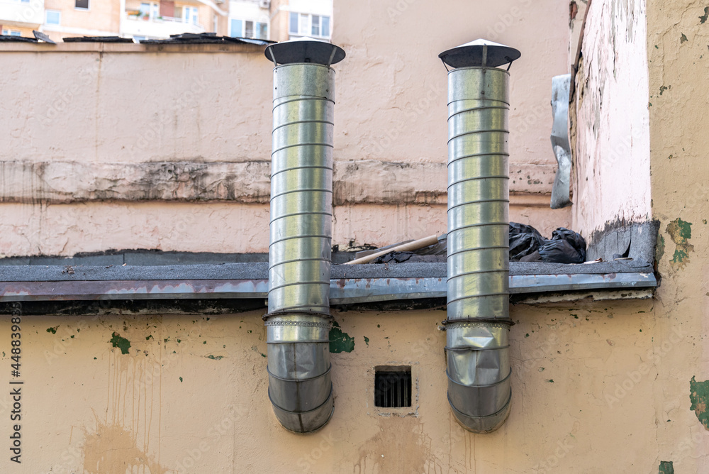 Galvanized steel ventilation and chimney pipes on the roof of the building. Galvanized steel ventilation and chimney pipes on the roof of the building.