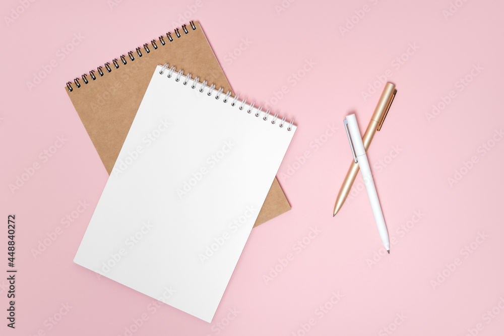 Notepad and pens on pink background Notepad and pens on pink background