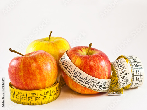 Apples with tape measure - illustrating healthy way to a weight loss