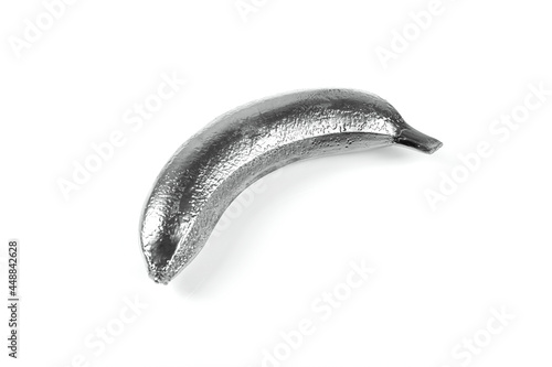 Silver banana isolated on a white background. Festive or summer concept. Flat lay.