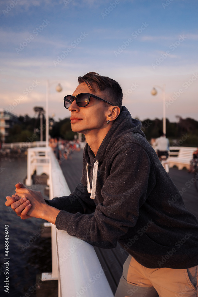 Active healthy young men enjoying sunset on a pier