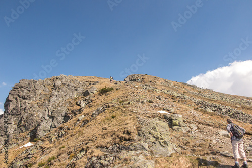 Mountain hiking along the Tatra trails in early summer in sunny weather. Western and High Tatras