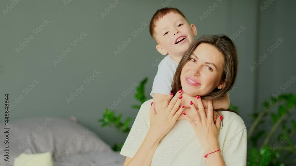 mother hugs with her toddler little son on a bed together. Family moments, children care. Motherhood, maternity leave concept mother hugs with her toddler little son on a bed together. Family moments, children care. Motherhood, maternity leave concept