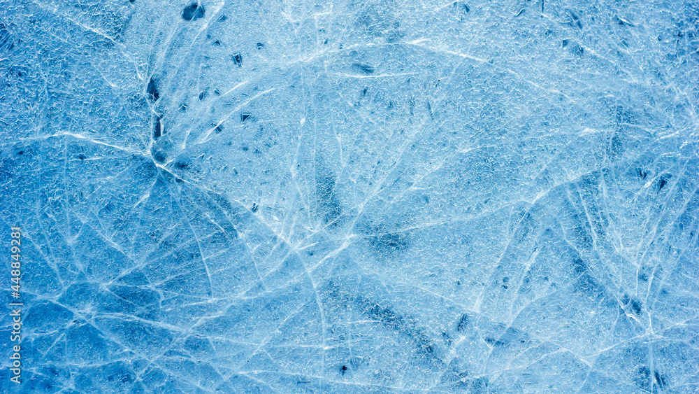 Beautiful ice texture with cracks of a frozen puddle on the asphalt for ...