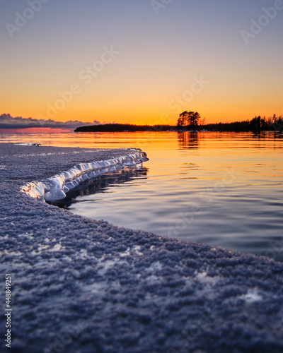 sunrise over the sea with ice on the foreground