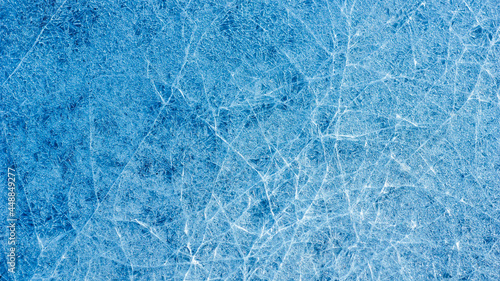 Beautiful ice texture with cracks of a frozen puddle on the asphalt for 3d texturing or design.