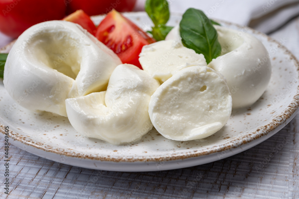 South Italian soft white mozzarella cheese made from buffalo cows milk served with ripe tomatoes and fresh green basil herb South Italian soft white mozzarella cheese made from buffalo cows milk served with ripe tomatoes and fresh green basil herb