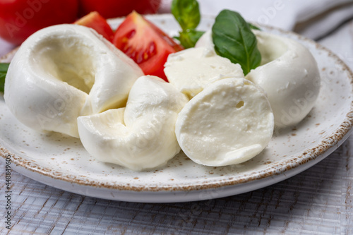 South Italian soft white mozzarella cheese made from buffalo cows milk served with ripe tomatoes and fresh green basil herb