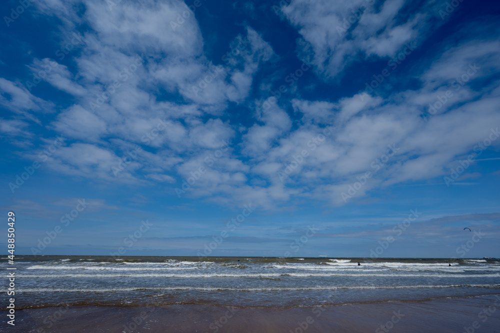 North sea waves and sandy beach in sunny day