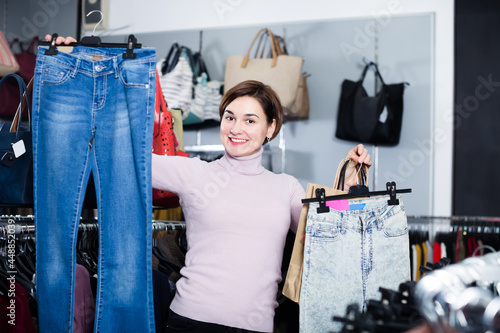 Woman enjoying her purchases in women cloths shop