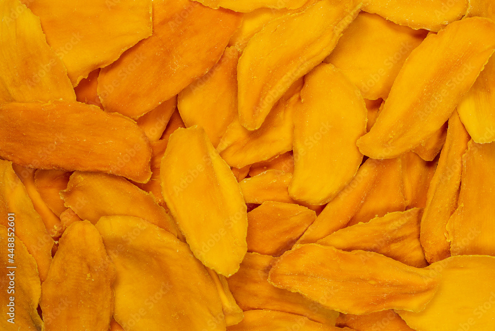Dry sugar mango slices as a background. Dry sugar mango slices as a background.