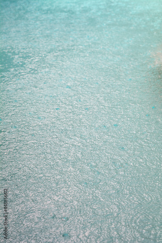 Rain drops in a turquoise pool