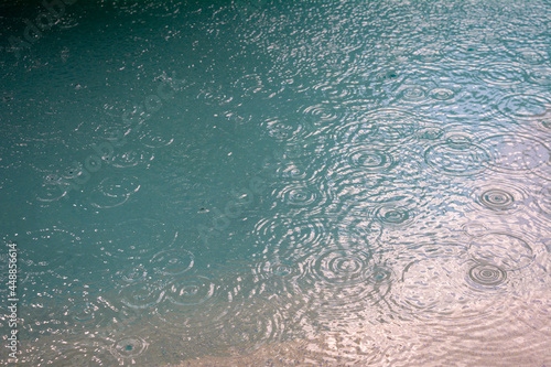 Rain drops in a turquoise pool