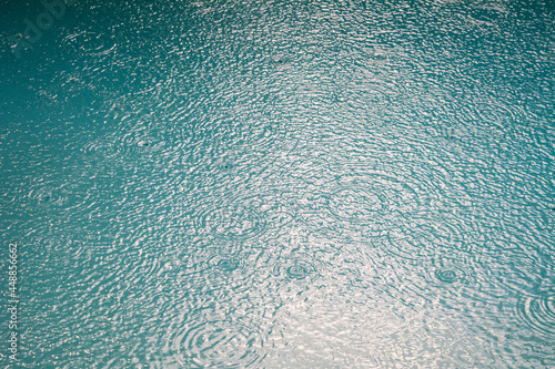 Rain drops in a turquoise pool