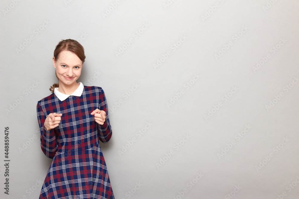 Portrait of happy blond young woman pointing with index fingers at you Portrait of happy blond young woman pointing with index fingers at you