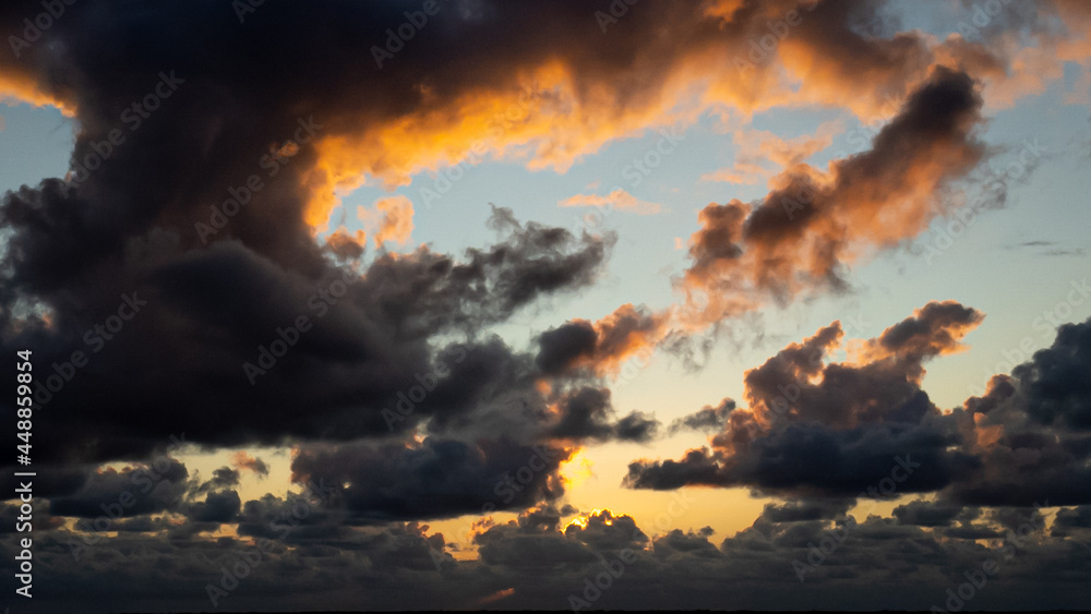 Wolken im Sonnenuntergang mit einem Loch, druch welches das abendliche Licht scheint