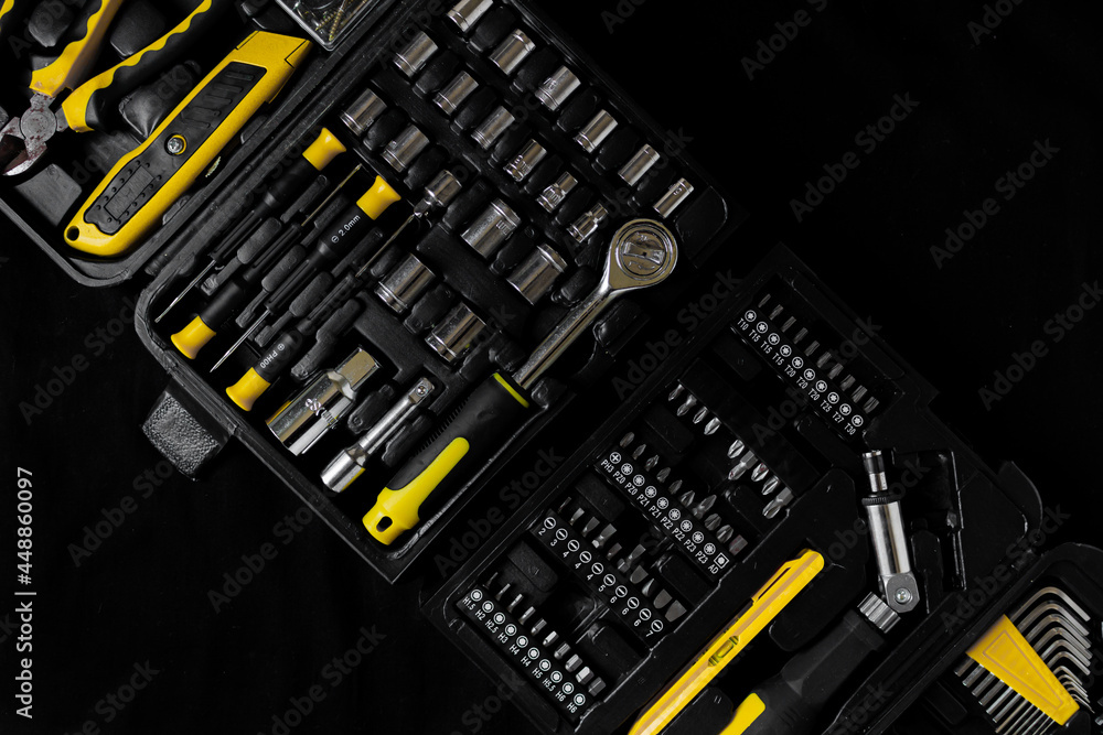 Maintenance, construction tools on black, dark background.