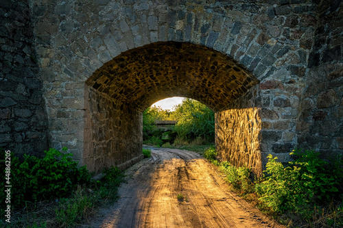 Old stone bridge and the light of the evening sun