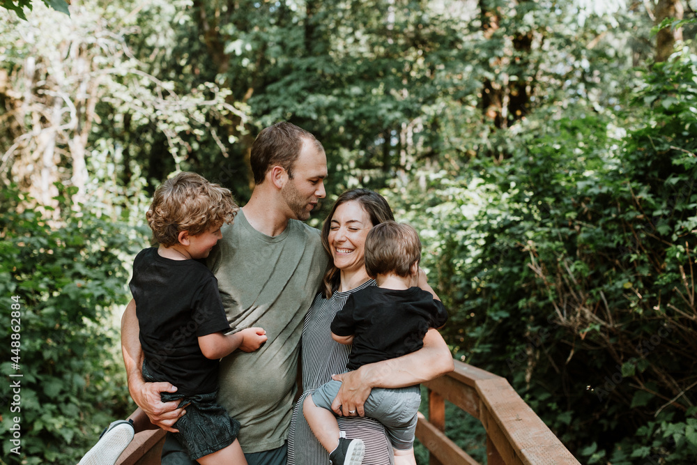 Happy, Affectionate Family in Wooded Park Happy, Affectionate Family in Wooded Park