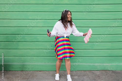 Happy Fijian female laughing outside green cottage