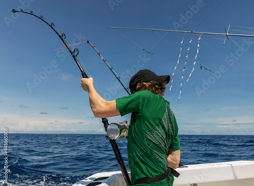  Boy Holding fishing Rod while  Sportfishing on Boat  photo