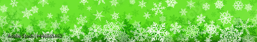 Banner of complex Christmas snowflakes with seamless horizontal repetition, in green colors. Winter background with falling snow