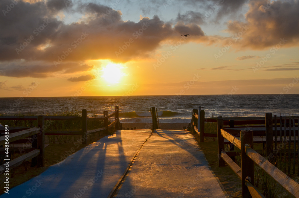 Fototapeta premium Accessible Beach mats on Walkway to Cape Cod Beach. Sunrise Ocean Beach view.