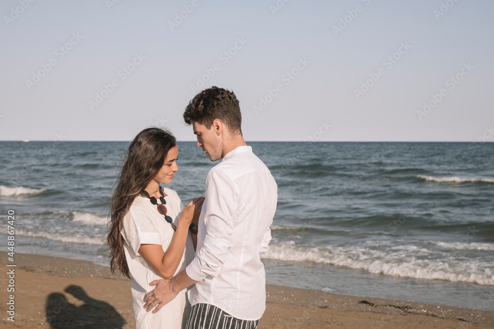 Young Couple In Love Walking On Te Shoreline Young Couple In Love Walking On Te Shoreline
