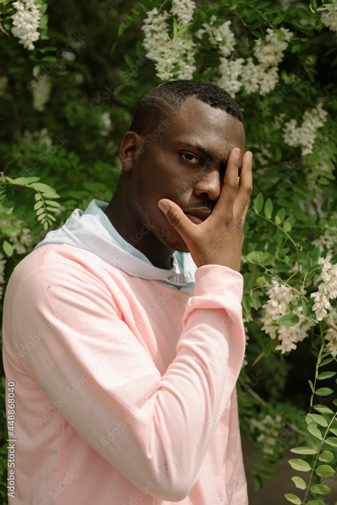 Portrait of guy near the blooming tree