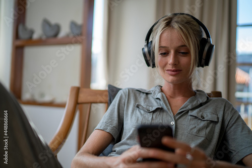 Woman listening music on her headphones photo