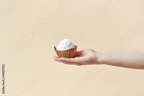 Woman holding ice cream in coconut shell photo