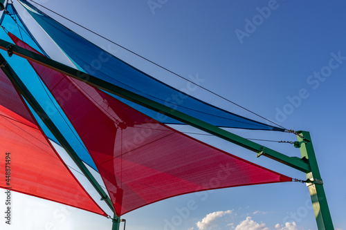 Sun shades in red and blue covering a play yard