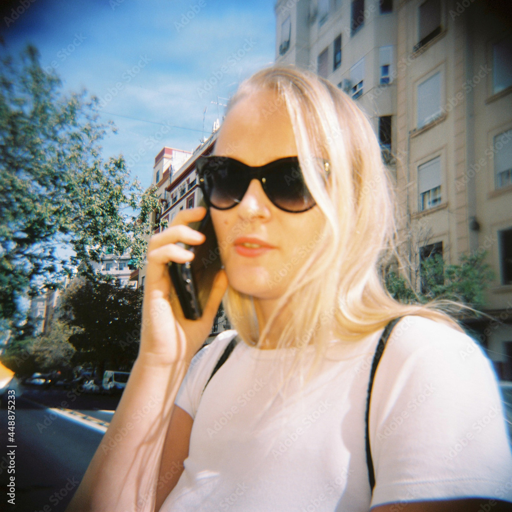 Woman speaking on smartphone on city street Woman speaking on smartphone on city street