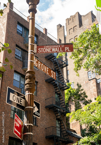 Obraz na płótnie New York, NY - USA - July 30, 2021: A street sign for Christopher Street; in the West Village neighborhood of Manhattan. Famous for the Stonewall Inn and the beginning of Gay Rights Movement. w salonie